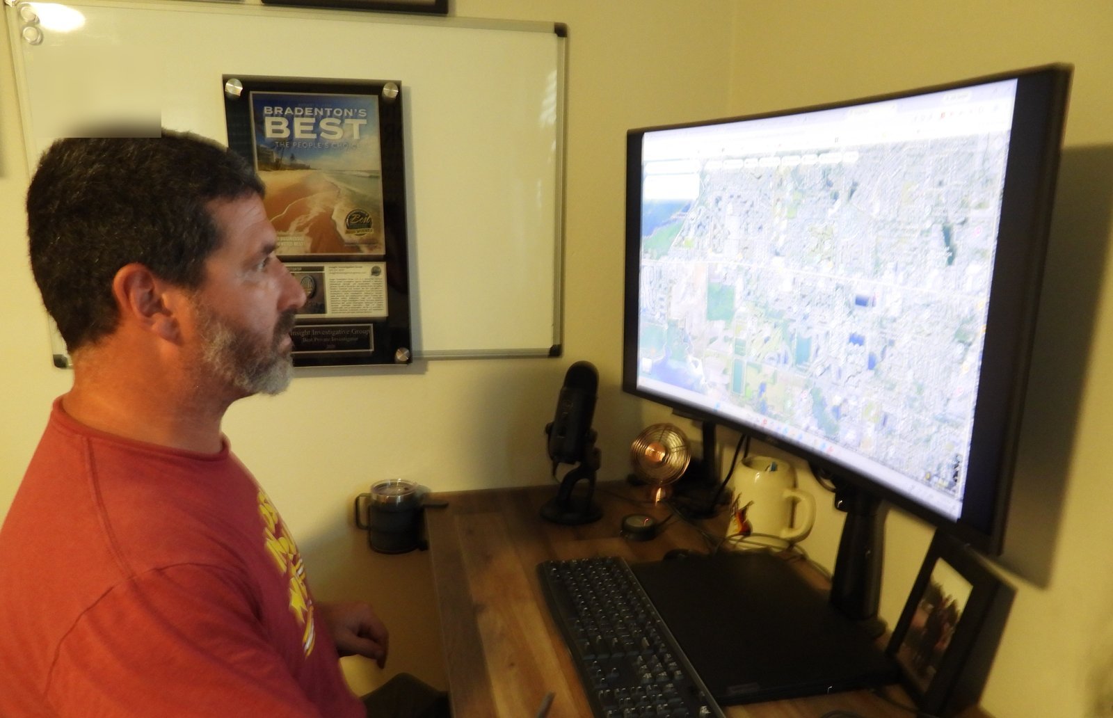 Joshua Goldberg, licensed private investigator, working a case at the Insight Investigative Group office in Bradenton, Florida, beneath the 2025 Bradenton’s Best plaque